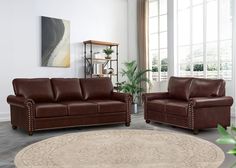 a living room with two brown couches and a round rug in front of a window