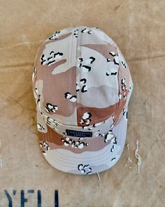 The 5-panel "camper" cap is preferred headgear in windy conditions due to its form fitting crown. Well suited for: fishing, hiking, boating, tennis, skating, running, cycling, and any activity where you are want to minimize having your cap whipped off your head! Made in USA. Chocolate Chip Deserts, Desert Chocolate, Camper Hat, Battle Dress, Desert Camo, Camouflage Print, Brand Marketing, Boating, Tri Color