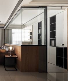 a living room filled with furniture next to a window covered in frosted glass doors