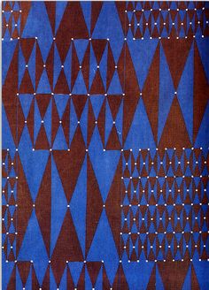 a blue and brown area rug with small white dots on the top of each pattern