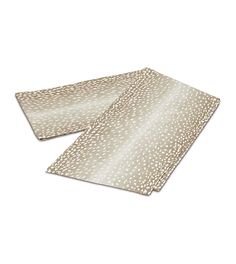 two placemats on top of each other, one with an animal print pattern