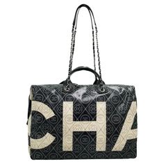 Auth CHanel Camelia Handbag/ Duffle Bag 31 Rue Cambone For Sale at 1stDibs | bolsa cambone Chanel Luggage, Black And White Chanel, Chloe 2024, Camelia Flower, 31 Rue Cambon, Metal Accents, Large Shoulder Bags, Large Letters, Chain Bag