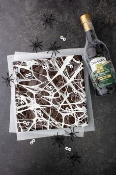 chocolate cake with white icing and spooky spider webs on the side