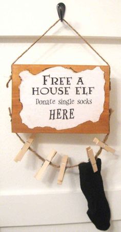 a sign hanging from the side of a door that says free a house elf donate single socks here