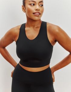 When you want it all, this smooth racerback style is what you need. This sports bra doubles as a workout top so you can effortlessly transition from the gym to the rest of your day. Sewn-in padding and stretchy fabric gives you medium support, seamless feel and none of the shifting. It’s all-around comfort plus a peek of cool mesh. And the secret to the extra pep in your step. | Knix Momenta Racerback Sports Bra in Black Racerback Activewear With Built-in Bra For Light Exercise, Racerback Sports Bra With Built-in Padding For Light Exercise, Versatile Sports Bra With Built-in Padding For Training, Sports Bra With Padded Back, Sports Stretch Bra With Padded Back, Padded Back Stretch Sports Bra, Stretch Activewear With Padded Back For Sports, Stretch Racerback Activewear With Padded Back, Solid Color Sports Bra With Built-in Bra, Racerback