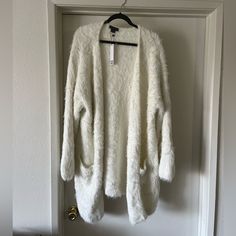 Beautiful White Oversized Fuzzy Cardigan. Perfectly Cozy For Fall And Winter. Very Soft. Not Itchy. Very Comfortable But Can Be Dressed Up. It Had One Little Cut On The Right Sleeve But I Did Alter It And You Can’t Tell It Was Ever Damaged. I Included A Picture Of It. Feel Free To Submit Offer. White Cozy Cardigan With Relaxed Fit, Cozy White Relaxed Fit Cardigan, White Oversized Cozy Cardigan, Oversized White Cozy Cardigan, Cozy Oversized White Cardigan, White Soft Knit Outerwear, One Size, White Soft Knit Outerwear One Size, One Size Soft Knit White Outerwear, Long Sleeveless Cardigan