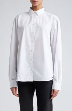 A slightly oversized fit and a high/low shirttail hem distinguish this classic button-up shirt cut from crisp organic cotton poplin. 27 1/2" front length; 30" back length (size 2US/34EU)   Front button closure   Point collar   Long sleeves with button cuffs   Curved hem   100% organic cotton   Dry clean or machine wash, dry flat   Made in Portugal   SPACE: A shop for emerging and advanced designers Classic Oversized Poplin Blouse, Oversized Classic Poplin Blouse, Poplin Shirt With Button Closure For Daywear, Oversized Classic Cotton Blouse, Classic Poplin Blouse For Daywear, Classic Oversized Cotton Blouse, Classic Poplin Blouse With Button Cuffs, Classic Blouse With Relaxed Fit And Shirttail Hem, Classic Shirt With Shirttail Hem And Placket