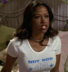 a woman wearing a hot rod t - shirt in a bedroom