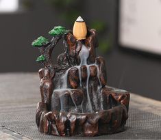 a small fountain made out of wood sitting on top of a table