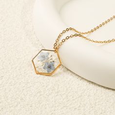 "Gold Forget Me Not Flower Necklace | Real Pressed Flower Necklace | Handmade Floral Necklace for Women | Birthday Gift | Valentine's Day Gift 【Pendant Size】: 20*20 mm 【Necklace Length】: 16/17/18 + 2\" 🌿The Gold Forget-Me-Not Flower Necklace is a beautiful piece of handmade floral jewelry that captures the essence of nature in a delicate and unique way. This necklace features real pressed forget-me-not flowers encased in a transparent resin pendant, creating a stunning and timeless piece that will complement any outfit. 🌿Benefits:  1. Unique and Memorable: With real forget-me-not flowers pressed and preserved within the pendant, this necklace is a one-of-a-kind piece that holds sentimental value. It serves as a constant reminder of cherished memories or loved ones.  2. Handcrafted with C Forget Me Not Flower, Pressed Flower Necklace, Women's Necklace, Transparent Resin, Art Deco Pendant, Dainty Pendant, Floral Jewelry, Women Birthday, Floral Necklace