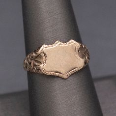 Wonderful Antique Victorian Shield Blank Signet Ring in 14k Gold This wonderful, handsome ring is awaiting its final fate- an engraved set of initials perhaps?  Or a coat of arms seal?  The Victorian ring is stamped 14k on the underside and features a face measuring about 11mm x 9mm, ready to leave as is or engrave.  The shoulders are also fantastic, with deep engravings of a floral pattern, and the band narrows at the base of the shank.  The ring is currently a size 8+ and can be resized before Classic Oval Signet Ring With Coat Of Arms, Classic Collectible Signet Ring With Coat Of Arms, Classic Signet Ring With Coat Of Arms For Anniversary, Classic Engraved Ceremonial Signet Ring, Classic Yellow Gold Engraved Ring With Coat Of Arms, Classic Engraved Signet Ring For Ceremonial Occasions, Classic Engraved Signet Ring For Ceremonial Use, Heirloom Oval Signet Ring With Coat Of Arms, Classic Formal Rings With Coat Of Arms