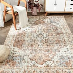 an area rug in a living room with wooden furniture and white drawers on the wall