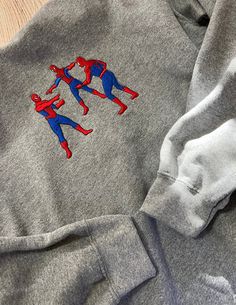 Spiderman Trío embroidered hoodie. Long sleeve, gray, cotton hoodie. Made to order. Size S-2X available. Gray Hoodie With Embroidered Logo For Fall, Gray Embroidered Logo Hoodie For Fall, Gray Fall Hoodie With Embroidered Logo, Gray Hoodie Sweatshirt With Embroidered Logo, Gray Embroidered Logo Hoodie Sweatshirt, Gray Sweater With Embroidered Logo For Streetwear, Gray Sporty Hoodie With Embroidered Logo, Sporty Gray Hoodie With Embroidered Logo, Gray Long Sleeve Hoodie With Embroidered Logo