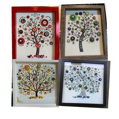 three framed artwork pieces with buttons on them, one is a tree and the other two are