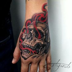 a hand with a skull and flames on it