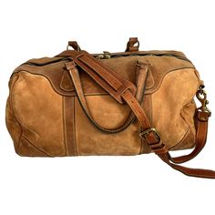 a brown duffel bag sitting on top of a white background