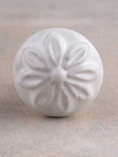 a white ceramic object sitting on top of a table