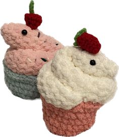 two crocheted cupcakes sitting next to each other