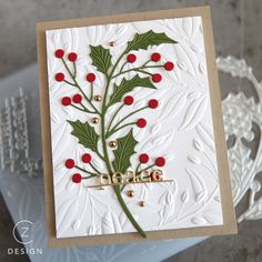 a christmas card with holly and red berries