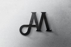 the letter m is made up of black metal