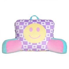 a purple and blue pillow with a smiley face on the front, sitting in front of a white background