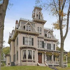 an old victorian style house in the fall