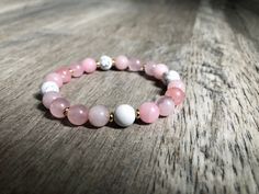 This handmade beaded bracelet is made with 8mm Howlite & Rose Quartz beads along with 2mm gold spacing beads. Strung on elastic stretchy cord. Properties: *Rose Quartz- restores trust & harmony in relationships/ purifies and opens the heart *Howlite- helps reduce levels of stress & anger/ absorbs negative energy  ------The average bracelet size is 6.5-7 inches. Measure your wrist to find your perfect sized fit!------ Healing Pink Bracelets With Spacer Beads, Pink 8mm Beaded Bracelets For Meditation, Pink Stretch Bracelet With Natural Stones For Meditation, Pink Spiritual Gemstone Beads Stretch Bracelet, Pink Natural Stones Stretch Bracelet For Meditation, Pink Round Beads Stretch Bracelet For Meditation, Spiritual Pink Hand-strung Stretch Bracelet, Pink Stretch Bracelet With Natural Stones, Beautiful Chokers