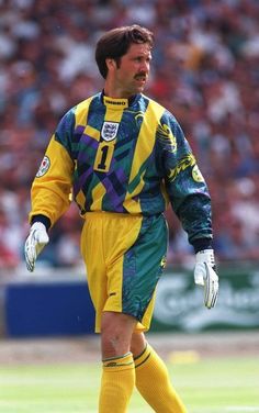 a soccer player in yellow and green uniform on the field