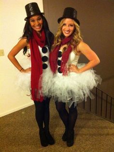 two women dressed in costumes posing for the camera