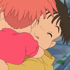 two children are hugging each other on a bed with blue sheets in the background and one child has red hair