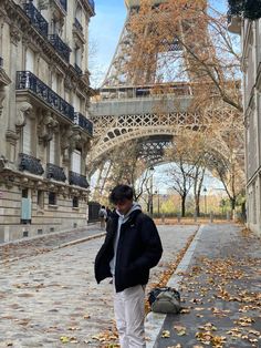 a man standing in front of the eiffel tower