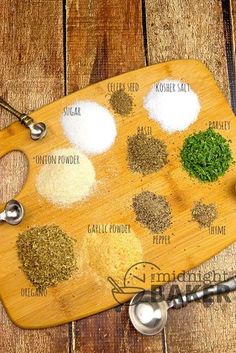 a wooden cutting board topped with different types of spices and seasoning on top of it