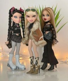 three dolls are standing next to each other