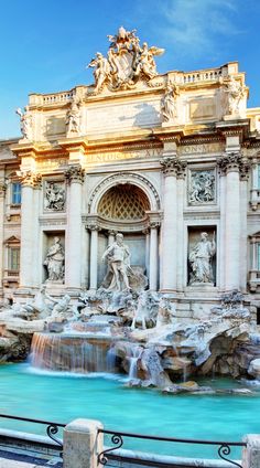 an image of the front of a building with water and statues on it's sides