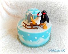 there is a cake that has penguins on it