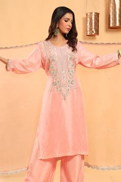 Baby pink silk kurta with heavily embroidered neckline in silver metal threads,  sequins, cutdana and salma work. Paired with an ombre dupatta in organza with pittan work. Comes with a pant.
Components:3
Embroidered
Neckline:Round
Sleeve Length:Three Quarter
Fabric:Kurta and Pant: Silk; Dupatta: Organza
Color:Pink
Embroidered neckline and sleeve hem
Scallop cutwork lace on dupatta hem - Aza Fashions Lace On Dupatta, Ombre Dupatta, Silk Kurta Set, Cutwork Lace, Organza Embroidery, Pink Kurta, Silk Kurta, Embroidered Neckline, Silk Dupatta