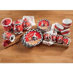 a wooden table topped with lots of red and white dishes covered in christmas themed decorations