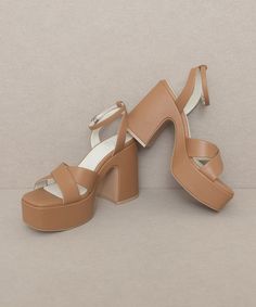 This gorgeous chunky sandal is bringing all the 70's glam. The Norah features a cross strap front and a sweet ankle buckle detail.Heel Height: 4.25"The front platform: 1.5"Types of closures: Slip on/ BuckleClog, Retro, Vintage Chic Block Heels With Chunky Platform And Open Heel, Brown Chunky Platform Sandals For Party, Brown Block Heel Wedge Sandals For Party, Chic Chunky Platform Sandals With Open Heel, Block Heel Wedge Sandals With Buckle Closure For Party, Chic Brown Chunky Platform Sandals, Party Wedge Sandals With Block Heel And Buckle Closure, Chic Chunky Platform Sandals With Ankle Strap, Summer Sandals With Cross Strap And Stacked Heel