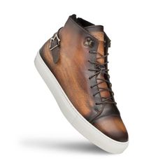 Style: Etched High Top Sneaker Cognac Unique Patina High Top Sneaker from the Mezlan collection features one of a kind Engraving on Hand-Burnished Patina Calfskin, Faux Fur Lining, Monkstrap Detailing on the Heel, their injected memory foam cushioned insole and a full Rubber Cup Sole! Handmade in Spain. Cordovan Shoes, Hi Fashion, Leather High Tops, Shoe Tree, Hi Top, Sneaker Brands, Monk Strap, Handmade Shoes, Suede Shoes