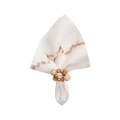 a white napkin with some gold decorations on the side and a bow tie around it