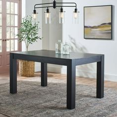 a black table sitting on top of a rug