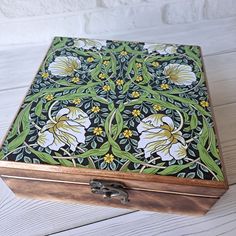 an intricately painted wooden box sitting on top of a table