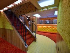 an indoor area with red carpet and stairs