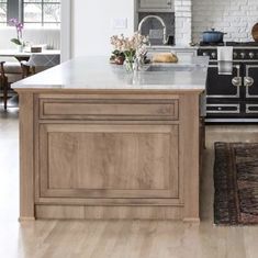 a kitchen with an island, stove and sink in it's centerpieces