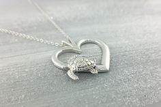 Sterling Silver Sea Turtle A sterling silver Sea Turtle, swimming on the side of a sterling silver heart :) A wonderful way to add this cute creature to your jewelry collection. The pendant includes a sterling silver curb chain. You can choose chain length (16,18 or 20 inches) from the drop-down menus. D E T A I L S * Heart: 1 inch * Three Chain Lengths Available * All our sterling silver is nickel-free! L I K E ∙ W H A T ∙ Y O U ∙ S E E ? Matching Earrings * https://etsy.me/2Zl1Yk7 Turtle Desig Cute Silver Heart Pendant Jewelry, Cute Silver Double Heart Jewelry, Cute Silver Heart-shaped Jewelry, Cute Silver Heart Jewelry, Cute Silver Heart Shaped Jewelry, Cute Double Heart Silver Jewelry, Cute Heart Shaped Silver Jewelry, Cute Sterling Silver Heart Pendant Jewelry, Sea Turtle Swimming