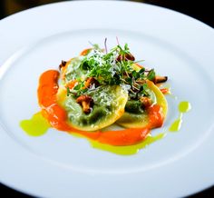 two white plates topped with food on top of a table