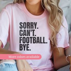 Show off your "Football Mom" pride with this witty and fun "Sorry. Can't. Football . Bye." t-shirt! Perfect for any youth Football enthusiast, this casual graphic tee is ideal for game days or everyday wear. Available in various colors to match your style. ⚾ Playful Design: Featuring a bold and humorous message, this shirt is perfect for baseball fans who prioritize the game. 🌈 Custom Colors: Choose from a range of colors to find the perfect fit for your personal style. 👕 Comfortable Fabric: M Football Mom Shirts Ideas Diy, Pink Crew Neck T-shirt For Game Day, Pink T-shirt With Team Name For Sports Season, Pink Team Spirit T-shirt With Team Name, Team Spirit Pink T-shirt With Team Name, Cotton Tops With Funny Text For Sports Events, Pink Crew Neck T-shirt For Sports Events, Sporty Pink T-shirt With Slogan, Team Spirit Pink Tops For Game Day