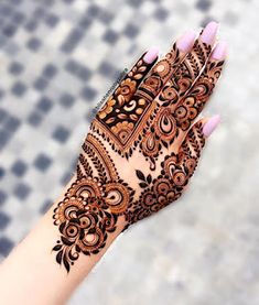 a woman's hand with henna on it