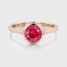 Experience timeless beauty with our Round Cut Bezel Lab Grown Ruby Ring in 14K rose gold, a perfect choice for solitaire, bridal, and anniversary gifts. Rose Gold Solitaire Ring, Gold Solitaire Ring, Ruby Engagement Ring, Aquamarine Rings, Affordable Jewelry, Gemstone Engagement Rings, Ruby Ring, Round Cut, Lab Diamonds