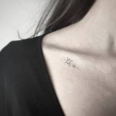 a woman's chest with a small tattoo on the left side of her neck